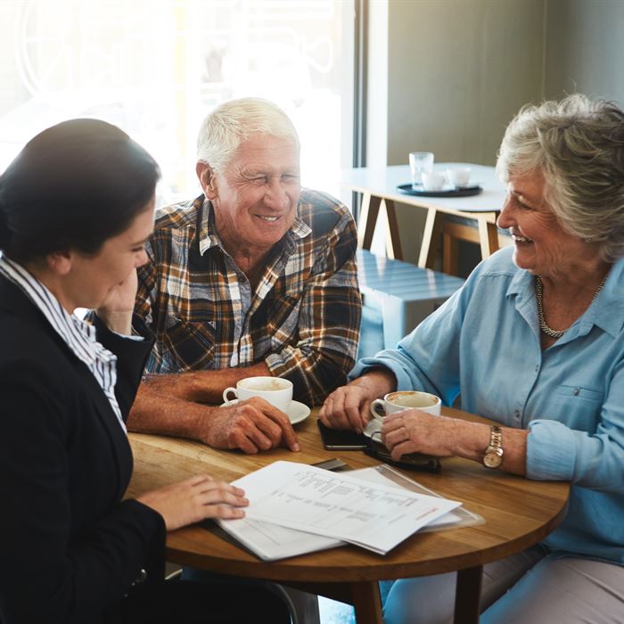 Senior living consultant having a meeting with an elderly couple