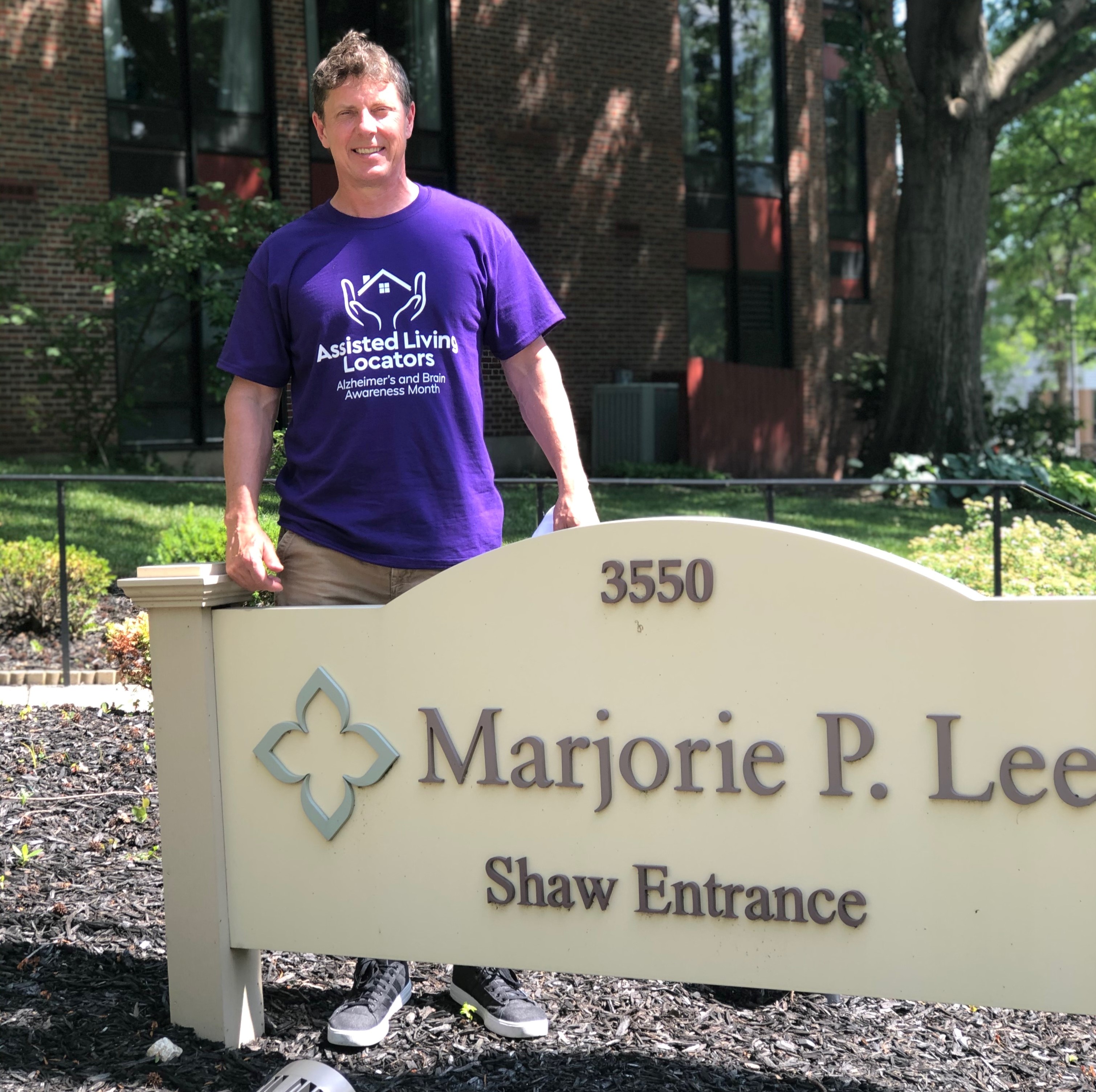 David Flautt standing in front of Majorie P. Lee Community Center Sign